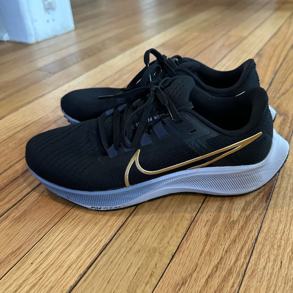 Nike Air Zoom Pegasus 38 in black and gold